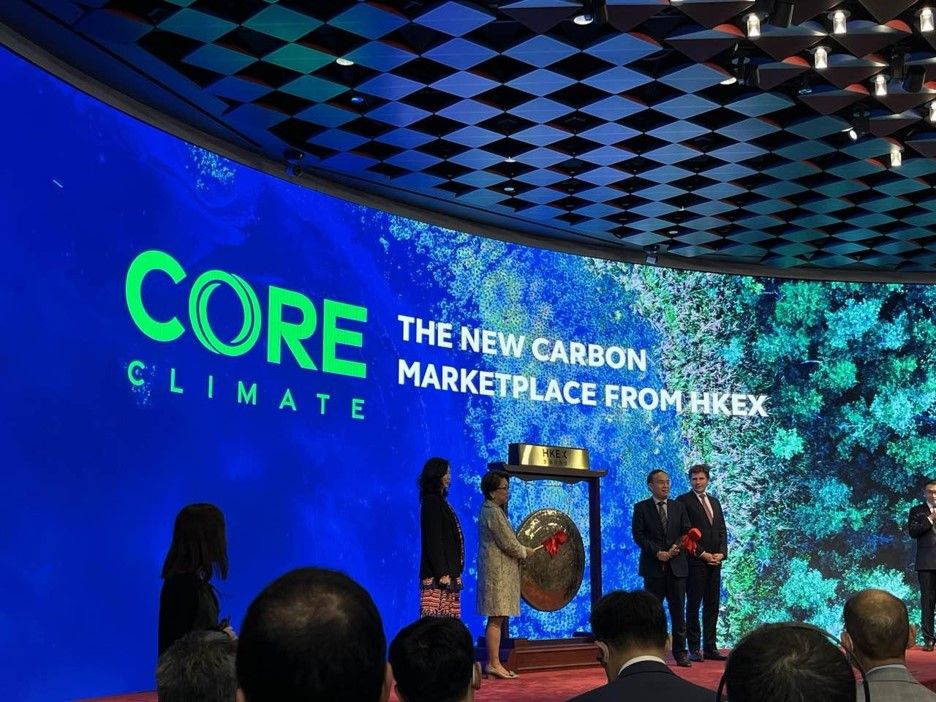 *HKEX Chairman Laura M Cha rings the gong to commemorate the launch of Core Climate, alongside Hong Kong Secretary for Financial Services and the Treasury Christopher Hui, and HKEX CEO Nicolas Aguzin.