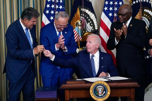 Biden signing the “Inflation Reduction Act”